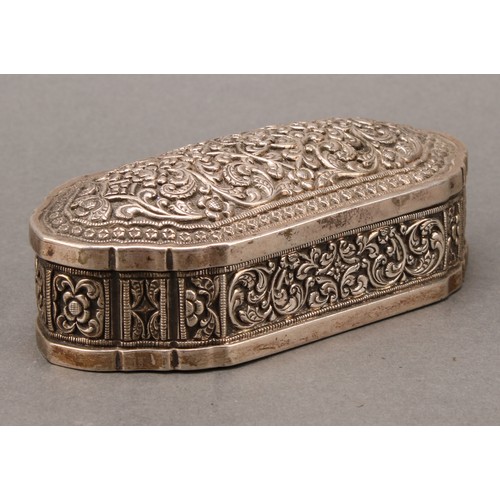 484 - An Indian silver shaped rectangular table snuff or tobacco box, profusely chased with lotus and scro... 