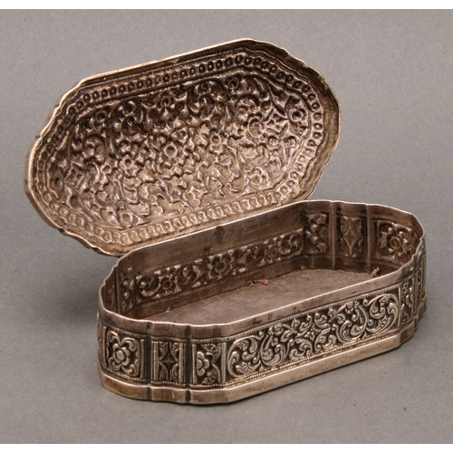 484 - An Indian silver shaped rectangular table snuff or tobacco box, profusely chased with lotus and scro... 