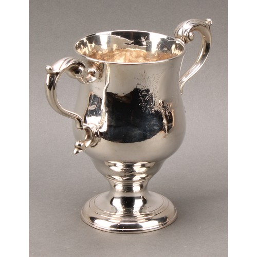 384 - A pair of George III Irish silver pedestal bell shaped loving cups, acanthus-capped scroll handles, ... 