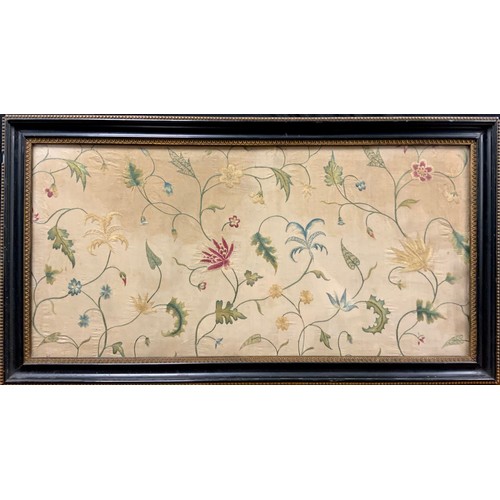 2102 - An 18th century needlework silk panel, possibly Irish, worked in coloured threads with flowers on sc... 