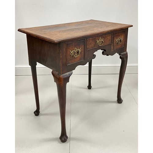 1689 - A George III walnut and mahogany cross-banded lowboy, oversailing rectangular top above three frieze... 