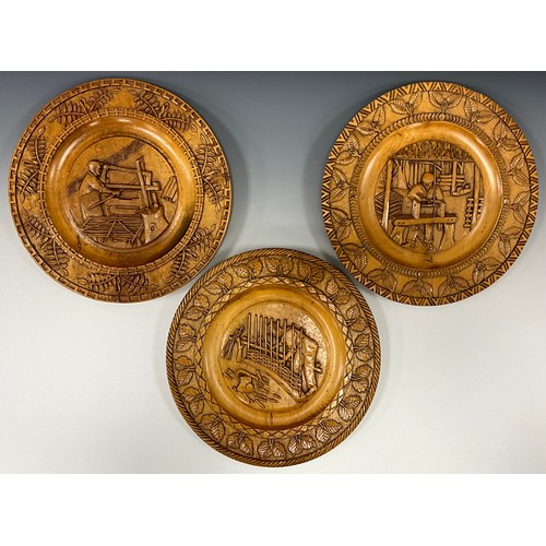 1545 - A set of three carved English field maple plaques, each with traditional craftsmen and past times in... 