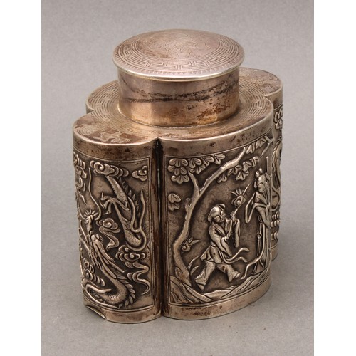 250 - A Chinese silver lobed oval tea caddy, chased in the Cantonese taste with figures and dragons, push-... 