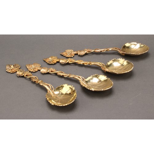 8 - A set of four George III silver-gilt serving spoons, cast throughout with fruiting vine, 20cm long, ... 