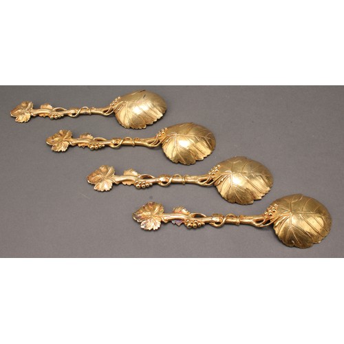 8 - A set of four George III silver-gilt serving spoons, cast throughout with fruiting vine, 20cm long, ... 