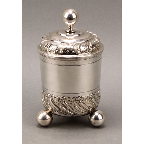 100 - A 17th century German silver beaker and cover, chased with bands of wrythen fluting and scrolling ac... 