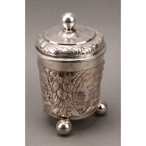 93 - A German silver beaker and cover, chased with a church and farm buildings, within cartouches on a gr... 