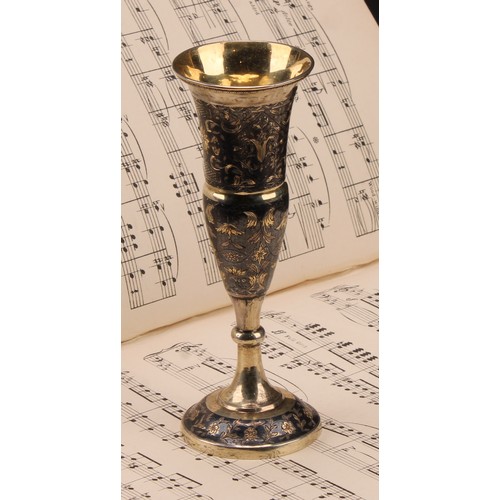 203 - A Russian silver-gilt and niello pedestal vase, bright-cut engraved with strapwork and scrolling lea... 