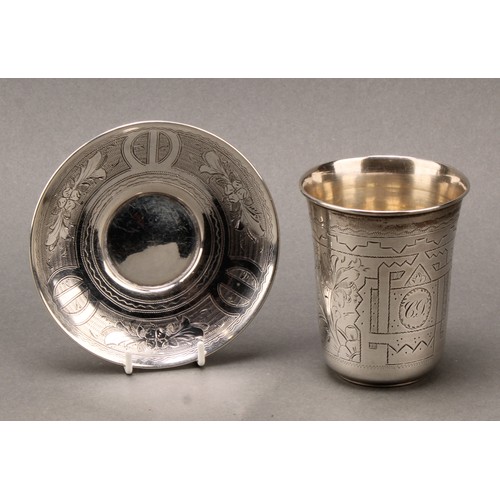 166 - A Russian silver beaker and stand, bright-cut engraved with strapwork and wrigglework, gilt interior... 