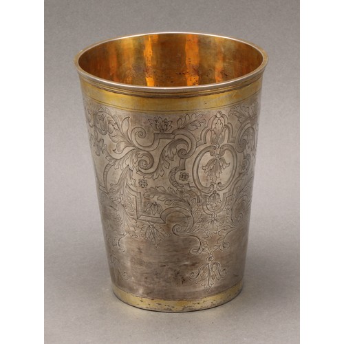 97 - A large 18th century Russian parcel-gilt silver tapered cylindrical beaker, engraved throughout with... 