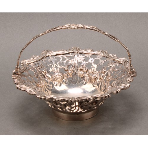 343 - A George III silver swing-handled sweetmeat basket, pierced and cast with flowering swags, trellis a... 