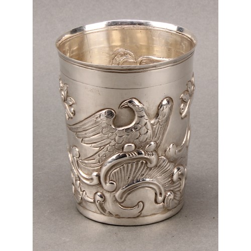 446 - An 18th century Russian silver tapered cylindrical beaker, chased with eagles, Classical pedestals, ... 