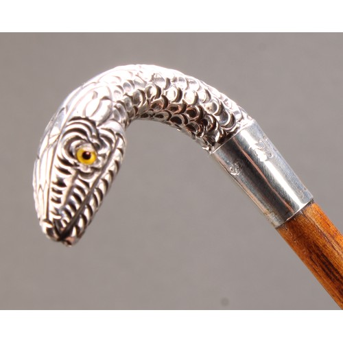 1764 - An Edwardian silver mounted walking stick, the handle as a snake's head, palmwood cane, glass eyes, ... 