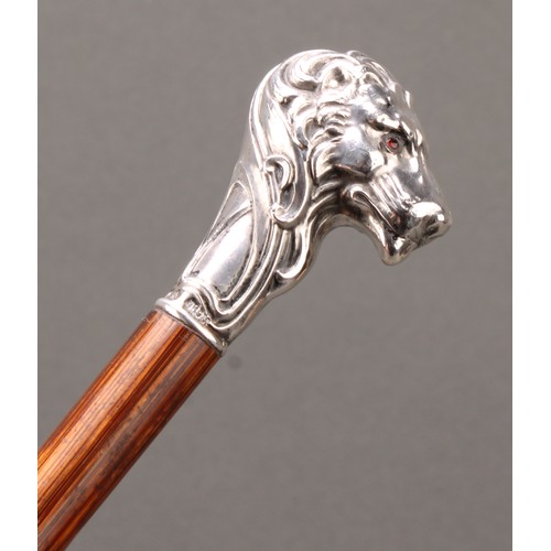 1759 - An Art Nouveau silver mounted walking stick, the pommel as a lion's head, ruby eyes, palmwood cane, ... 