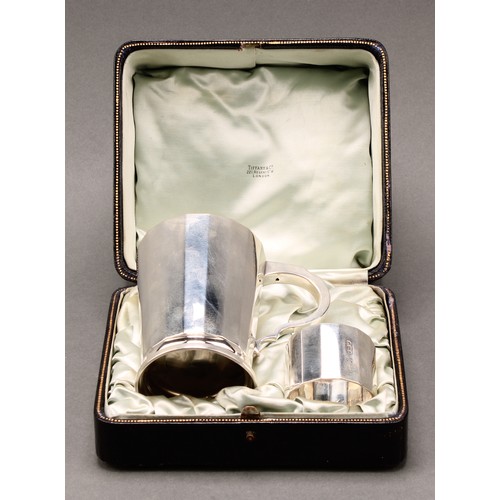 233 - Tiffany & Co - a George V silver christening mug and napkin ring, of substantial gauge, the mug 9.5c... 