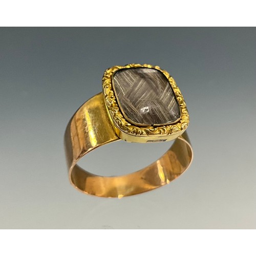 528 - A 19th century mourning ring, hairwork lattice braid within floral collar, unmarked yellow/rose meta... 