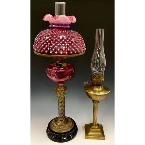 2003 - A Victorian cranberry and opaline glass oil lamp, Fenton hobnail wavy top shade,  25.5cm diameter, a... 