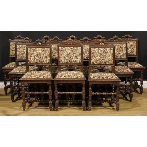 1910 - A set of twelve late Victorian Carolean Revival oak dining chairs, each with stuffed-over back and s... 