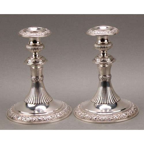 235 - Tiffany & Co - a pair of American silver candlesticks, half-fluted campana sconces and pillars, chas... 