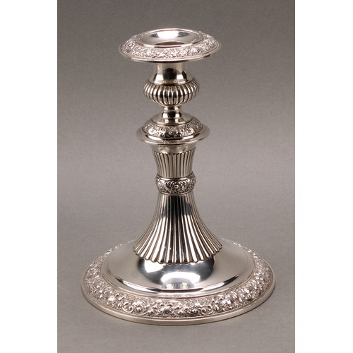 235 - Tiffany & Co - a pair of American silver candlesticks, half-fluted campana sconces and pillars, chas... 