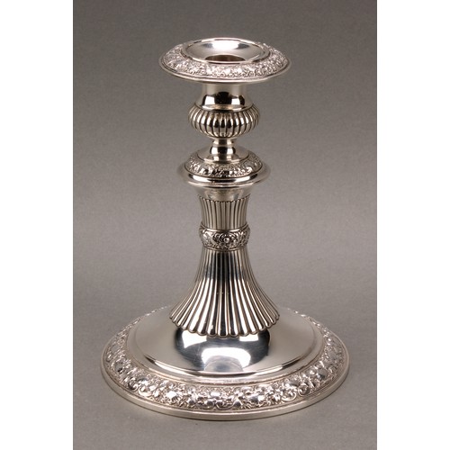 235 - Tiffany & Co - a pair of American silver candlesticks, half-fluted campana sconces and pillars, chas... 