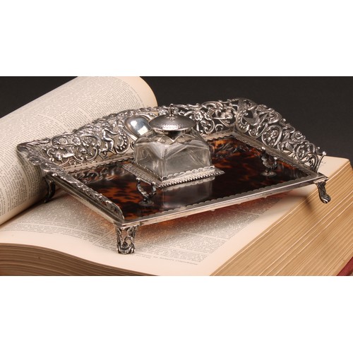 169 - A Victorian silver and tortoiseshell inkstand, the pierced three-quarter gallery cast with putti, bi... 