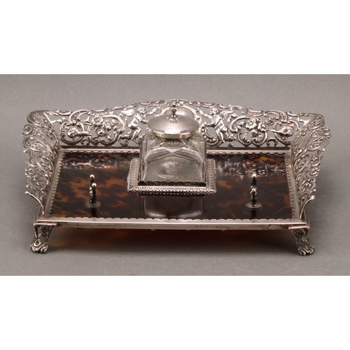 169 - A Victorian silver and tortoiseshell inkstand, the pierced three-quarter gallery cast with putti, bi... 