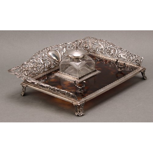 169 - A Victorian silver and tortoiseshell inkstand, the pierced three-quarter gallery cast with putti, bi... 