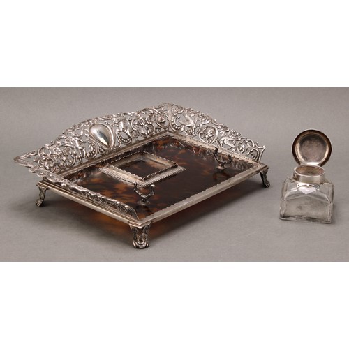 169 - A Victorian silver and tortoiseshell inkstand, the pierced three-quarter gallery cast with putti, bi... 