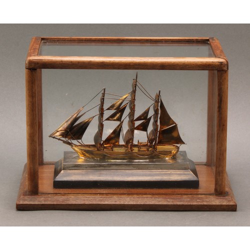 86 - A George VI silver and silver-gilt maritime model, of a sailing ship, glazed mahogany case, 26.5cm l... 