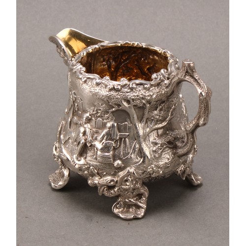 275 - A Victorian silver pear shaped Teniers cream jug, cast with tavern scenes, gilt interior, 8cm high, ... 