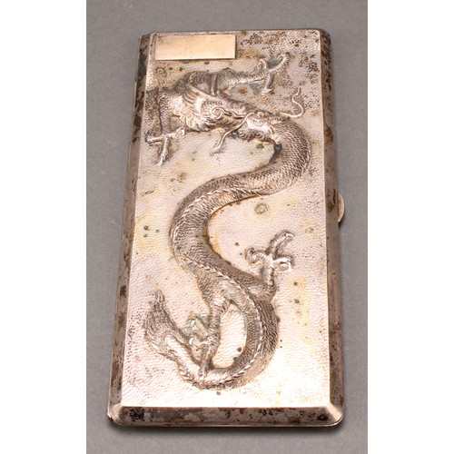 227 - A large Chinese silver rectangular cigarette case, hinged cover chased in bold relief with a dragon,... 