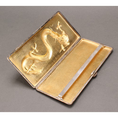 227 - A large Chinese silver rectangular cigarette case, hinged cover chased in bold relief with a dragon,... 