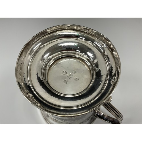 345 - A George III silver two handled cup, ridged handles, later decorated with scrolling folaite and latt... 