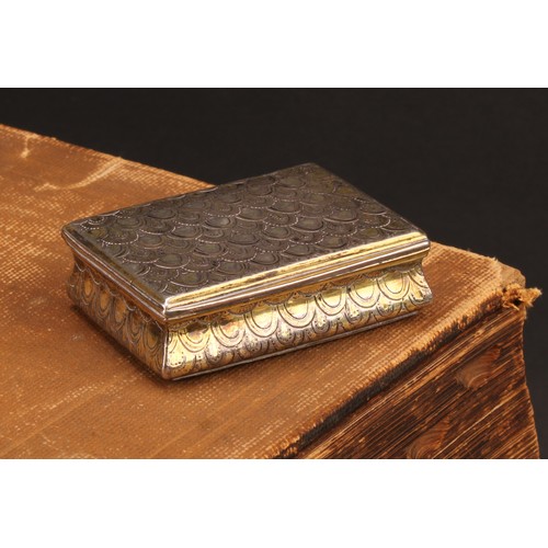 443 - An 18th century Continental silver-gilt waisted rectangular snuff box, chased overall with 'snake sk... 