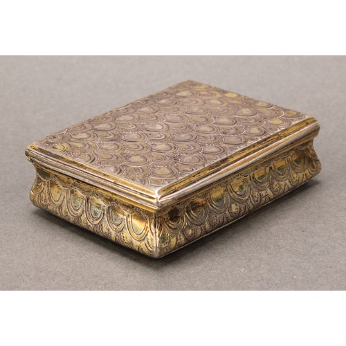 443 - An 18th century Continental silver-gilt waisted rectangular snuff box, chased overall with 'snake sk... 