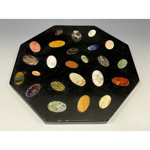 2109 - A granite and pietra dura octagonal table top, inset with oval shaped specimens of lapis lazuli, whi... 