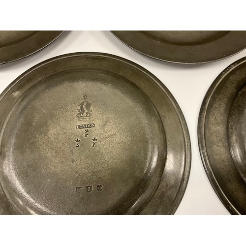 1665 - A set of five 18th century pewter dinner plates, London, crowned X marks to bases, 23.5cm diameter; ... 