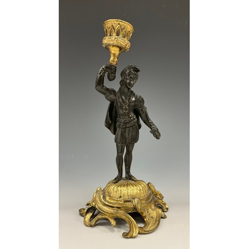 1520 - A 19th century Continental patinated bronze and ormolu figural candlestick, as a young man in Renais... 