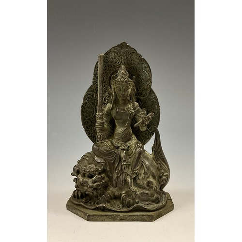 1705 - A 19th century Indian cabinet bronze, as Buddha seated on a Foo dog, octagonal base, 11cm high overa... 