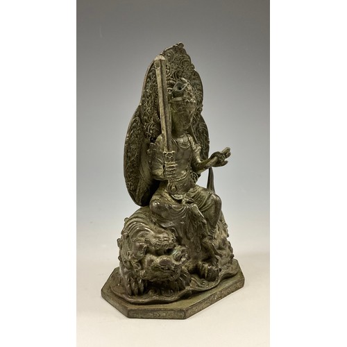 1705 - A 19th century Indian cabinet bronze, as Buddha seated on a Foo dog, octagonal base, 11cm high overa... 