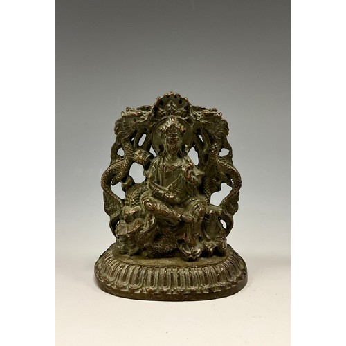 1704 - A 19th century Indian cabinet bronze, as a female Buddha, she sits on a Foo Dog flanked by a pair of... 