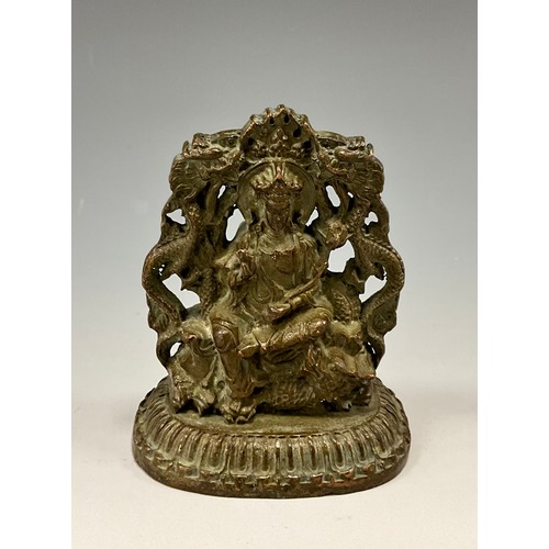 1704 - A 19th century Indian cabinet bronze, as a female Buddha, she sits on a Foo Dog flanked by a pair of... 