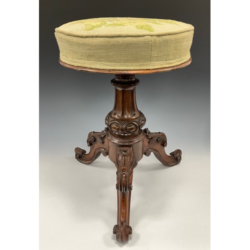 1787 - A Victorian rosewood piano stool, the extending and stuffed over seat worked in wool with fruiting v... 