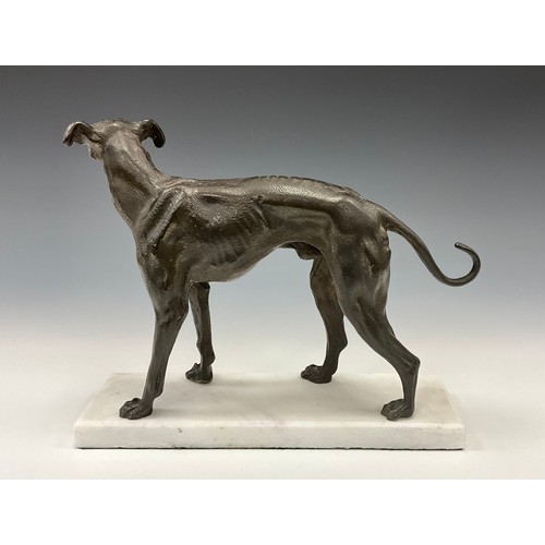 1643 - A dark patinated bronze, of a greyhound in trian aspect, rectangular marble base, 23cm high, 27cm lo... 