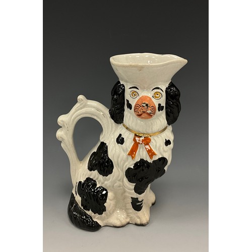 1192 - A 19th century Staffordshire character jug, as a spaniel sejant, 20cm high overall