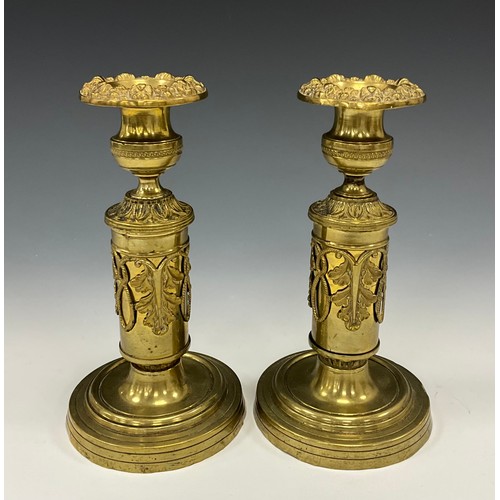 1853 - A pair of Regency brass candlesticks, floral drip pans, campana sconces, acanthus applied pillars, c... 