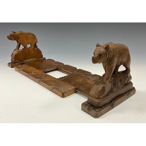 1544 - A 19th century Black Forest book carrier, the hinged ends carved as bears on rocky outcrops, applied... 