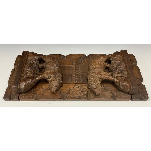 1544 - A 19th century Black Forest book carrier, the hinged ends carved as bears on rocky outcrops, applied... 