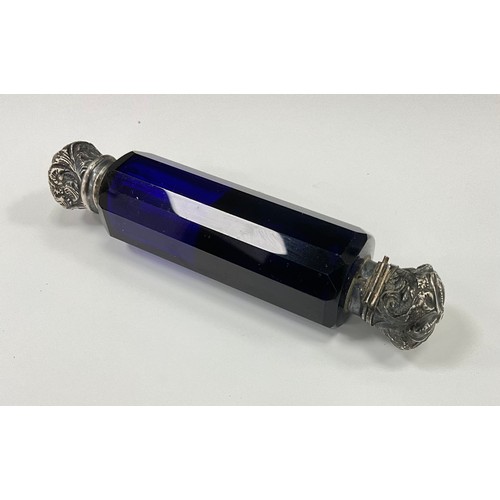 1865 - A Victorian Bristol blue glass and white metal mounted double ended scent bottle, the repousse cover... 